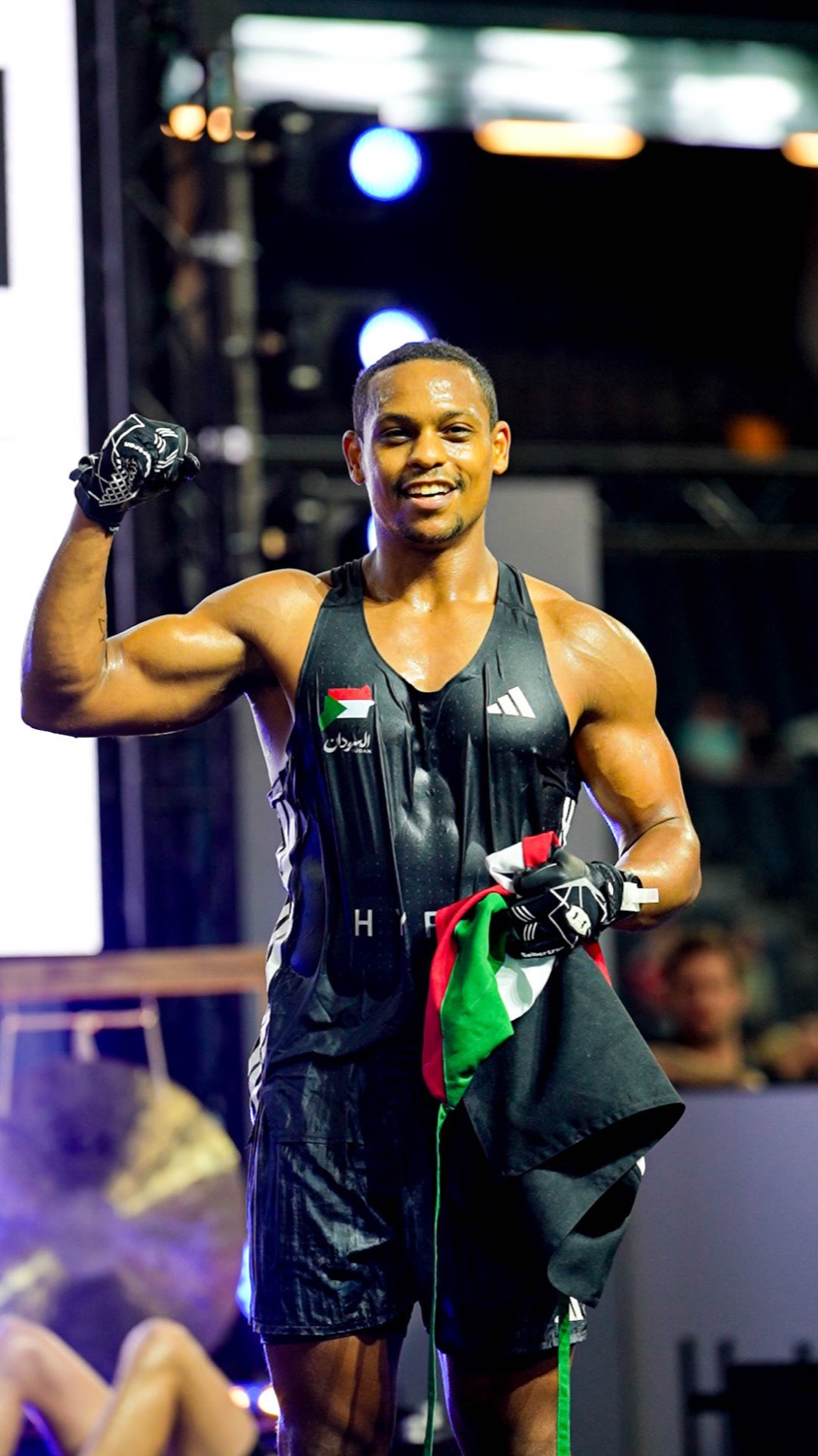 Ahmed Babiker celebrating at HYROX World Championships Stockholm with the Sudan flag